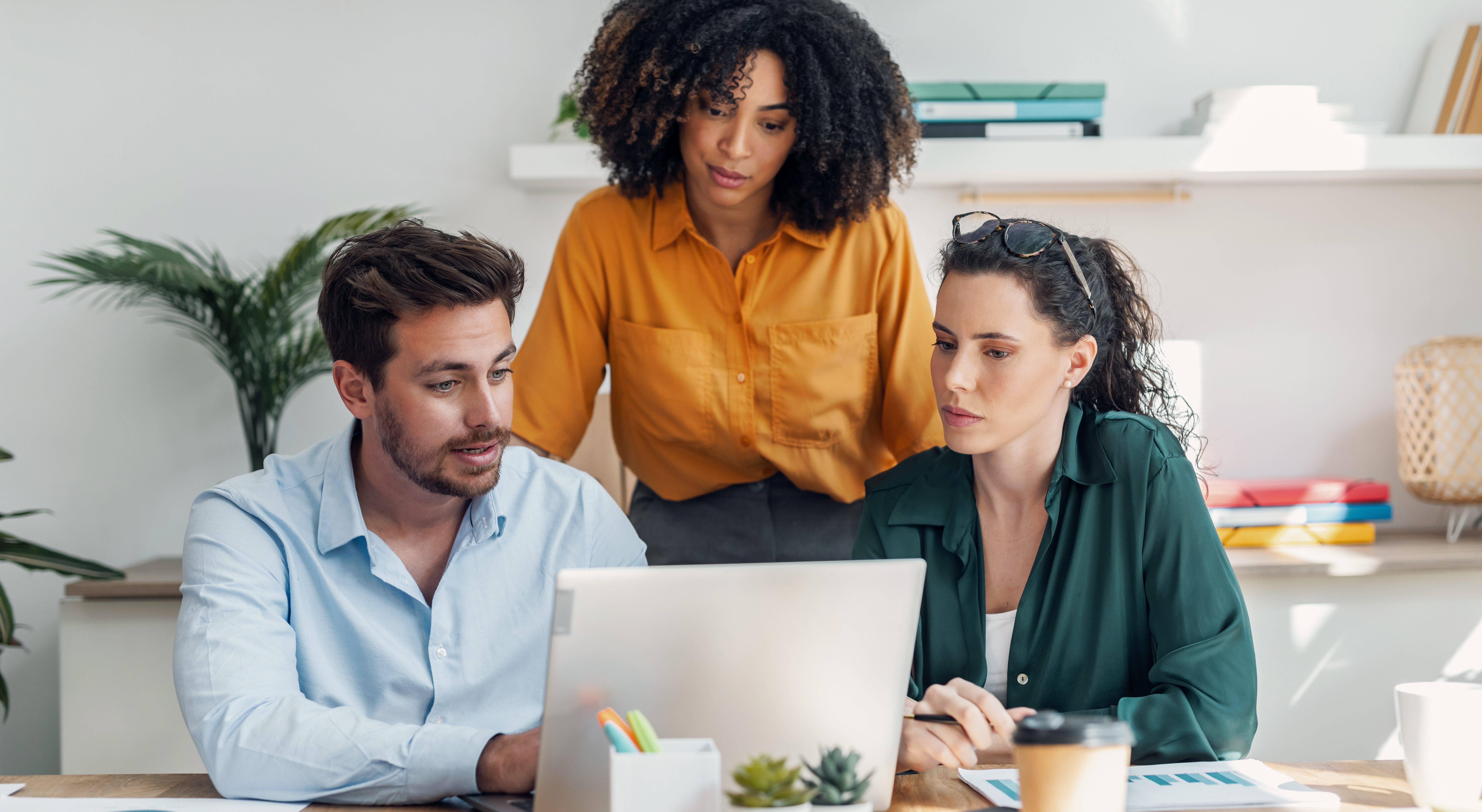 Group of professionals collaborating on a project in a office.